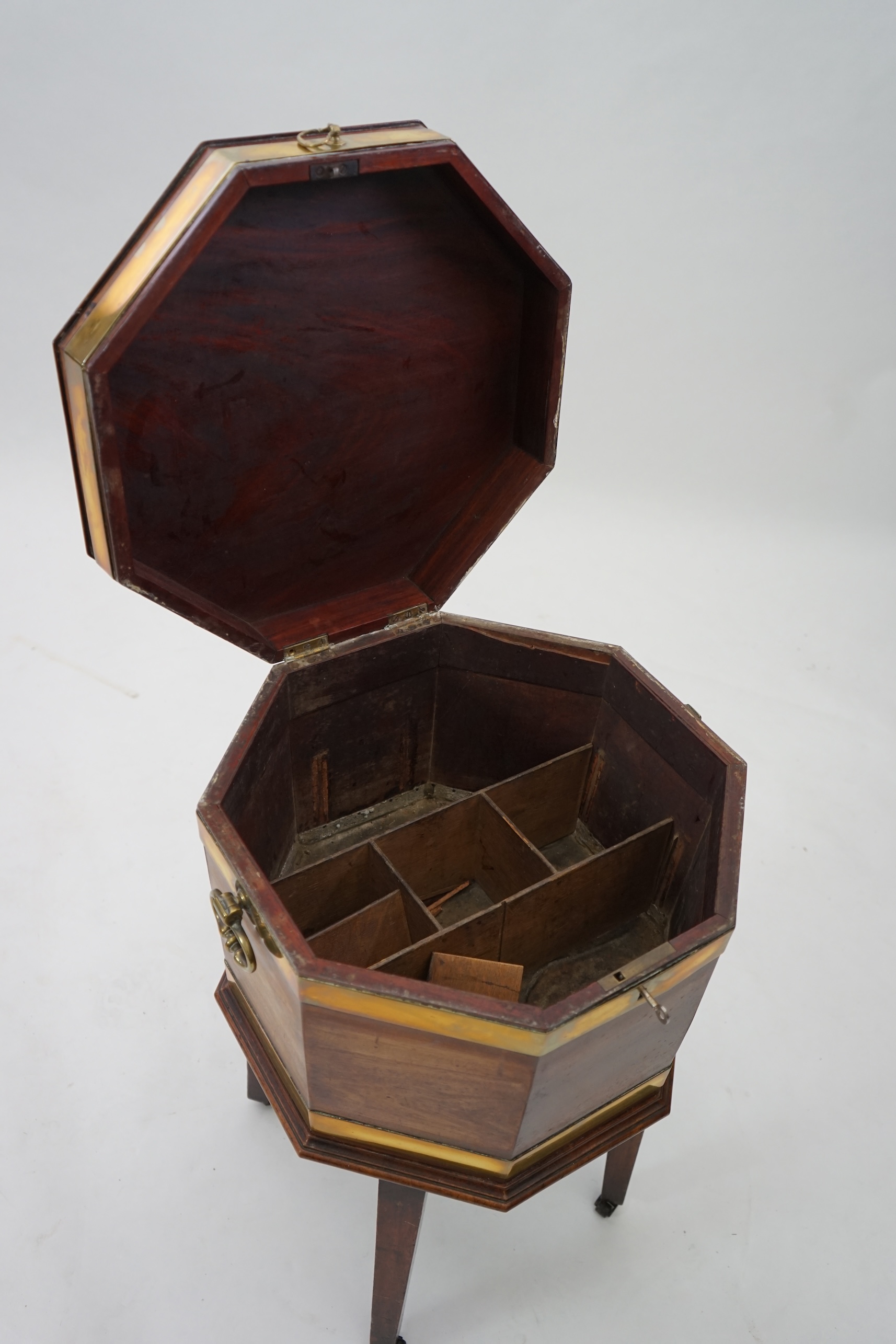 A George III mahogany triple brass banded octagonal cellarette